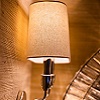 Sconce with gold seagrass wallpaper
